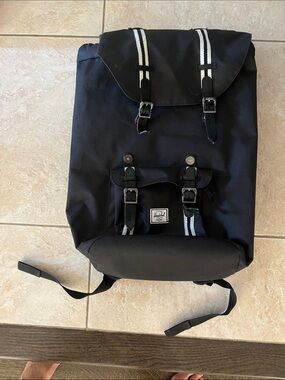 Hershel lightly used Black Backpack with White Stripe Accents